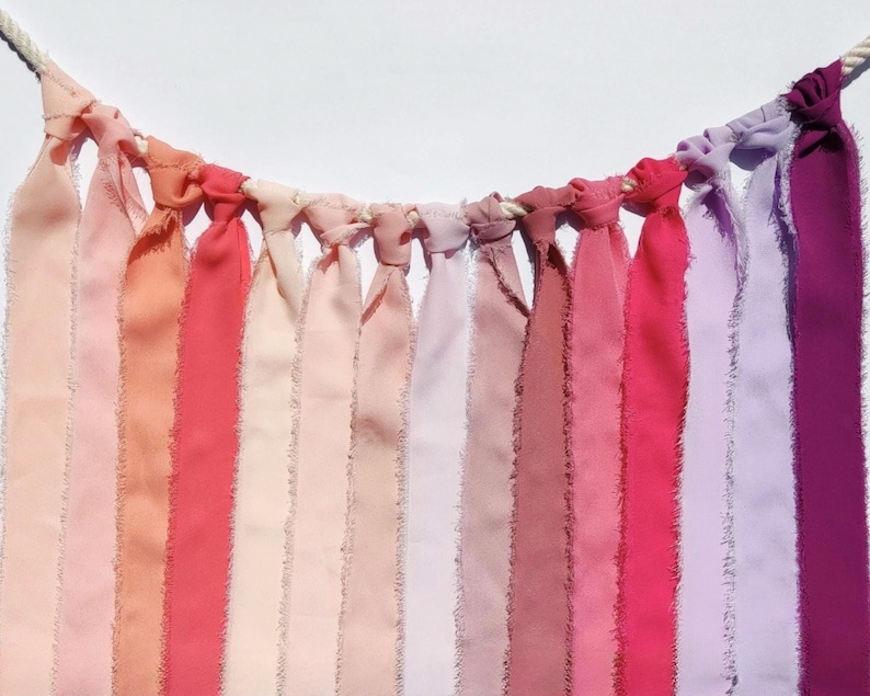 Floaty frayed edge chiffon ribbon in various pink shades, such as baby pink, soft pink, rose pink, salmon pink, coral pink, dusty pink, bubblegum, hot pink, lilac, magenta. 38mm width.