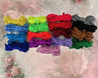 Puede incluir: Surtido de gomas elásticas de colores en varios colores, incluyendo rojo, verde, azul, morado y negro. Las gomas elásticas están dispuestas en filas y están listas para ser usadas para manualidades, cintas para el pelo u otros propósitos.