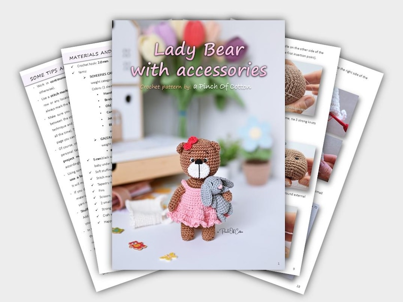 May include: A crochet pattern book titled "Lady Bear with accessories" featuring a crocheted bear wearing a pink dress and holding a gray bunny. The book includes instructions and tips, with additional pages visible.