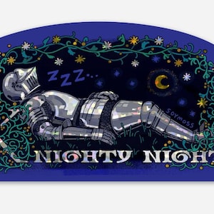 May include: A sticker featuring a sleeping knight in silver armor on a bed of grass under a starry night sky. The words "Nighty Night" are displayed in silver lettering, with a crescent moon and stars. The sticker has a dark blue background.