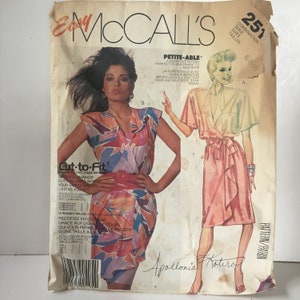May include: A vintage sewing pattern for a wrap dress with a ruffled hem. The pattern is for sizes 6-8-10 and is labeled "Petite-Able". The pattern is called "Cut-to-Fit" and is by McCall's.