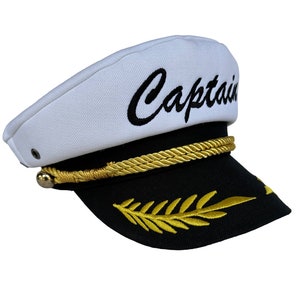 May include: A white captain's hat with a black embroidered "Captain" on the front. The hat has a black brim with a gold rope trim and a gold embroidered leaf design.