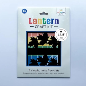 May include: A craft kit for making a leaf-themed lantern. The package features the words "Lantern CRAFT KIT" in colourful letters. The design includes black leaf cutouts and the text "A simple, mess free craft. Decorate with included stickers, no paint needed!"