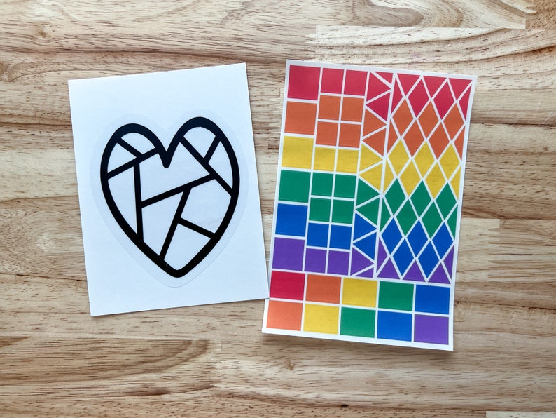 May include: Two printable activity sheets. One sheet features a black and white geometric heart design. The second sheet displays a rainbow-colored geometric pattern composed of squares, triangles, and diamonds. Both sheets are suitable for crafting or educational activities.