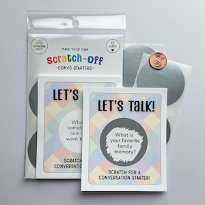 May include: A clear plastic package containing conversation starter cards. The cards have a pastel diamond pattern and the text "LET'S TALK!" and "SCRATCH FOR A CONVERSATION STARTER!". A penny is next to the cards.