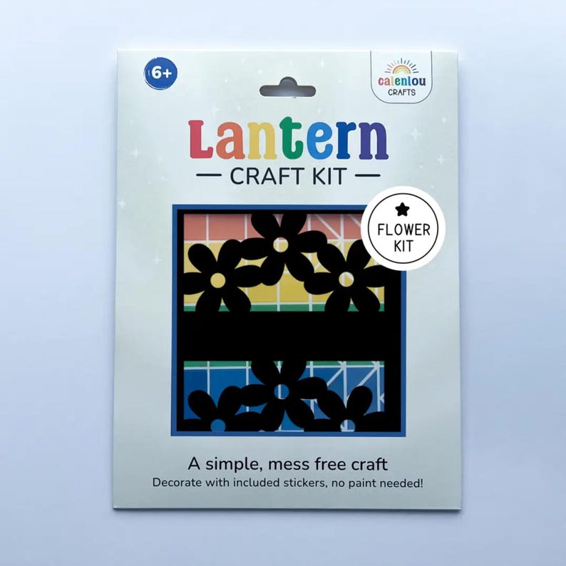 May include: A craft kit for making a lantern, featuring a flower design. The kit includes stickers and requires no paint. The package has the text "Lantern - CRAFT KIT - Flower Kit" and is suitable for ages 6+.