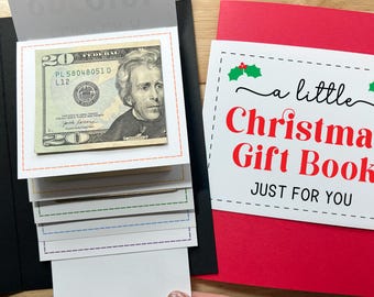 May include: A Christmas gift book with a twenty-dollar bill visible. The book has a red cover with the text "a little Christmas Gift Book JUST FOR YOU". The interior has pull-out tabs.
