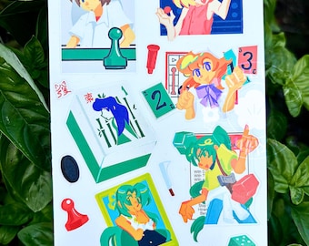 May include: A sticker sheet featuring anime-style illustrations of characters and game-related elements. The designs include a board game, dice, playing cards, and various character poses. The sticker sheet has the text "ajinaew" at the bottom.