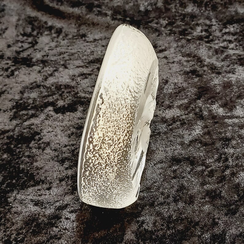 May include: A clear glass ashtray with a textured surface and a raised design. The ashtray is shaped like a heart.