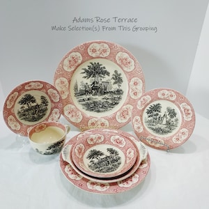 May include: Adams Rose Terrace dinnerware set featuring cream-colored ceramic pieces with black pastoral scenes and pink floral borders. The collection includes plates, a bowl with handles, and a teacup, all displaying the text Adams Rose Terrace Make Selection(s) From This Grouping.