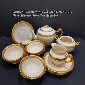 May include: A vintage Lenox J19 cream tea set with gold leaf accents. The set includes a teapot, creamer, sugar bowl, cups, and saucers.  The set is in excellent condition and is perfect for a tea party or special occasion.