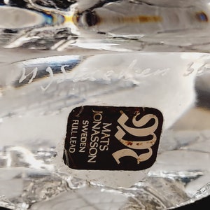 May include: Close-up of a black and gold label with the text "Mats Jonasson Sweden Full Lead" and the letter "S" in a stylized font.