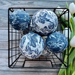 Basket filled with French toile decor balls.