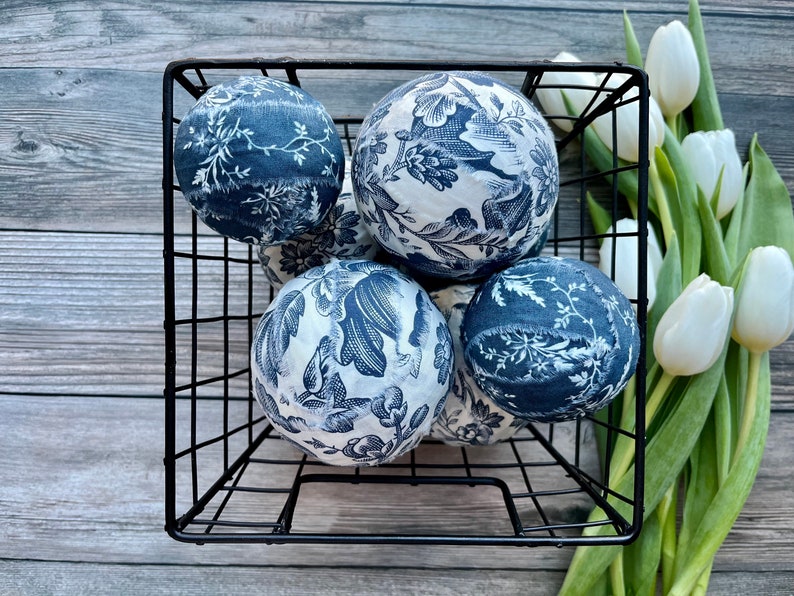 Basket filled with French toile decor balls.
