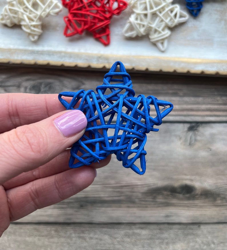 May include: A blue woven star ornament. The star is made of thin, woven strips of material and is a deep blue color.