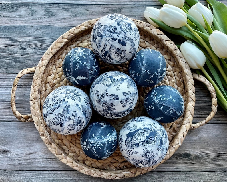 Wicker basket with blue and white toile decor balls.