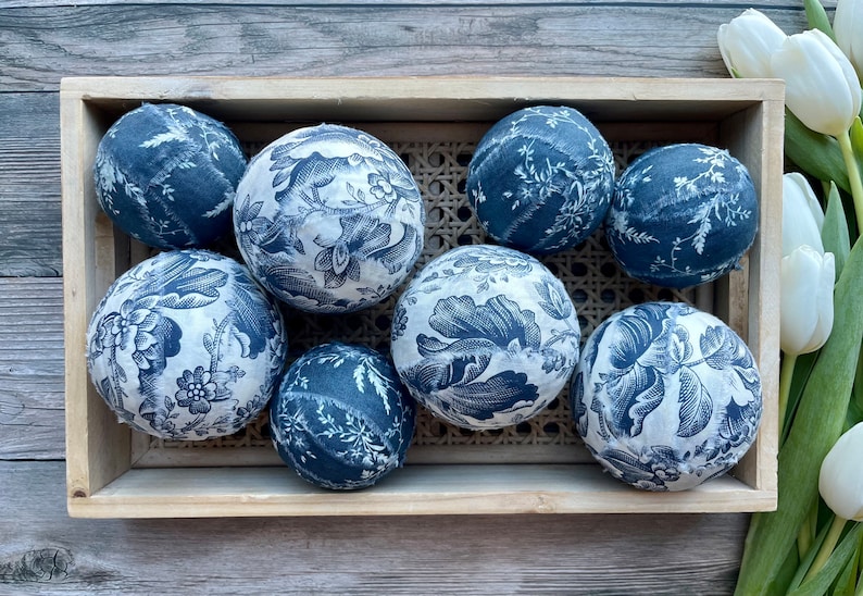 Wicker basket with blue and white toile decor balls.