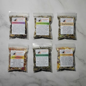 May include: Six clear plastic bags of dried food mixes for crabs, each labeled with a different name and ingredients. The labels include "Hermies Wormies", "Crabby's Cravings", "Bug Barbeque", "Sunset Supper", "Greens Galore", and "Tropical Blend".