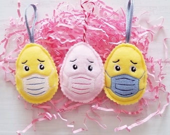 Embroidered felt egg in fase masks