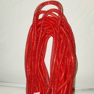 May include: A roll of red glitter mesh ribbon. The ribbon is rolled up and tied with a white ribbon.