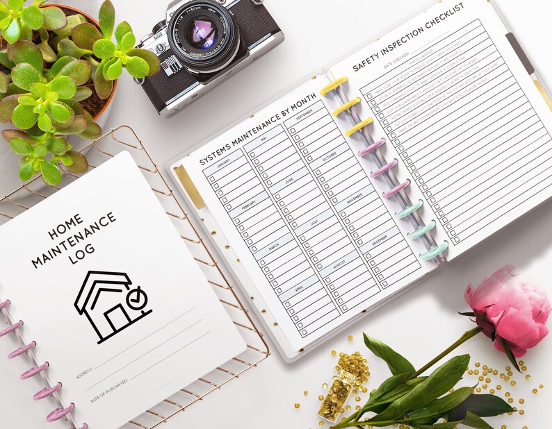 May include: Two white planners with black text. The planner on the left is labeled "Home Maintenance Log" and has a house icon with a checkmark. The planner on the right is labeled "Systems Maintenance by Month" and "Safety Inspection Checklist".