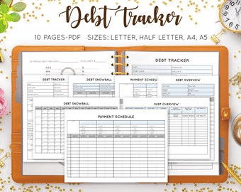 May include: A tan leather binder with spiral-bound pages labeled "Debt Tracker." The pages include charts for tracking debt, payment schedules, and debt overviews. The text on the pages is in black and blue. The image also includes a clock and coffee.