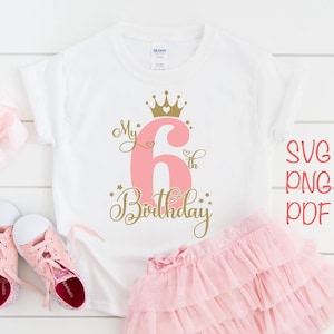 May include: A white t-shirt with a pink number six and gold crown, stars, and the text "My 6th Birthday".