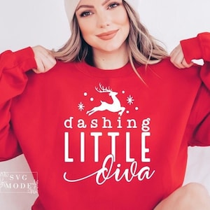 May include: Red sweatshirt with a white graphic of a reindeer and the text "dashing little diva".