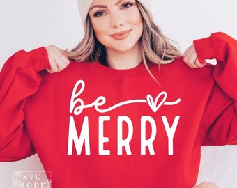 May include: Red sweatshirt with white text that says "be merry" with a heart above the word "merry".