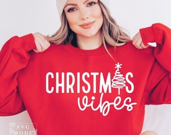 May include: Red sweatshirt with white text that says "Christmas vibes" and a stylized Christmas tree graphic.