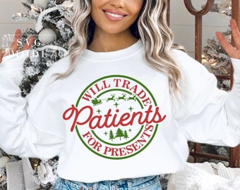 May include: White sweatshirt with a green and red circular design that says "Will Trade Patients for Presents" with a Santa Claus and reindeer graphic.