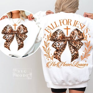 May include: White sweatshirt with a leopard print bow and the text "Fall for Jesus. He Never Leaves".