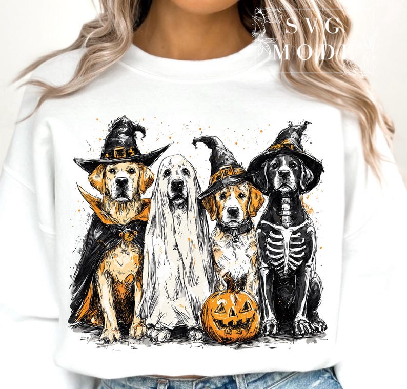 May include: White sweatshirt featuring a Halloween-themed graphic. The graphic depicts four dogs dressed in costumes: a witch, a ghost, a witch, and a skeleton, with a carved pumpkin. The dogs are in shades of black, white, and gold.