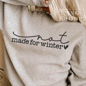 May include: Grey sweatshirt with the text "not made for winter" and a small heart.