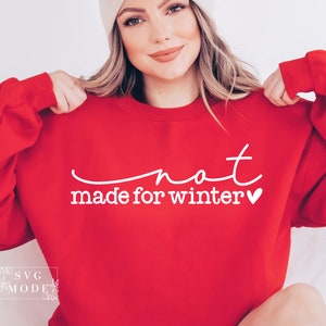 May include: Red sweatshirt with white text that says "not made for winter" with a small heart.