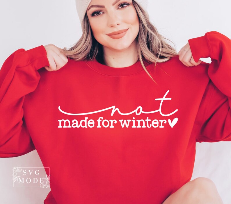 May include: Red sweatshirt with white text that says "not made for winter" with a small heart.