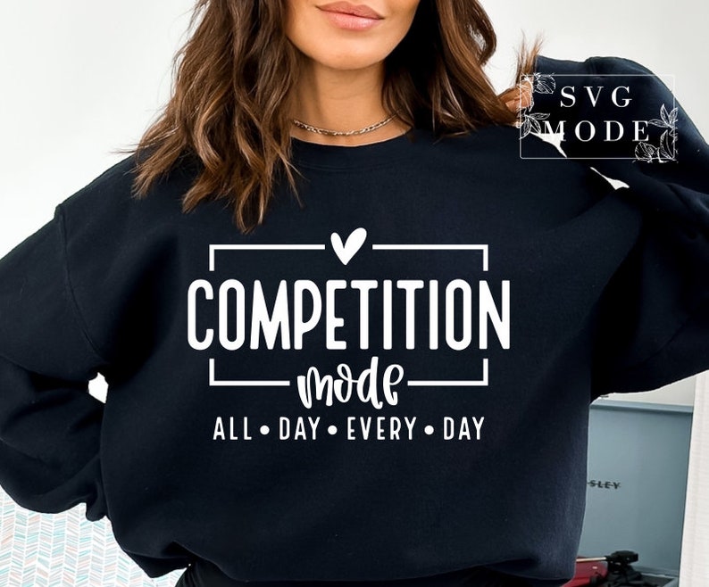 May include: Black sweatshirt with white text that reads "Competition Mode All Day Every Day" with a heart above the word "Competition".