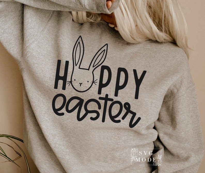 May include: A gray sweatshirt with the text "Hoppy Easter" in black lettering. A black and white cartoon bunny face is above the text.