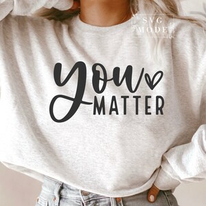 May include: A gray sweatshirt with the text "you matter" in black lettering with a small heart symbol.