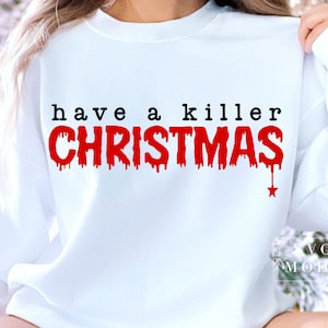 May include: White sweatshirt with the text "have a killer CHRISTMAS" in black and red. The word "CHRISTMAS" has a dripping blood effect, with a small red star at the bottom. The sweatshirt is a casual holiday themed apparel.