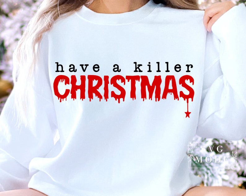 May include: White sweatshirt with the text "have a killer CHRISTMAS" in black and red. The word "CHRISTMAS" has a dripping blood effect, with a small red star at the bottom. The sweatshirt is a casual holiday themed apparel.