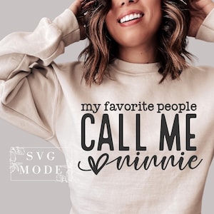 May include: A beige sweatshirt with the text "my favorite people CALL ME Minnie" in black lettering with a heart graphic.