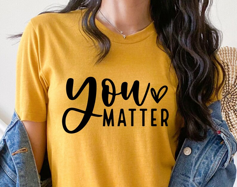 May include: A yellow t-shirt with the text "you matter" in black script with a small heart symbol after the word "you".