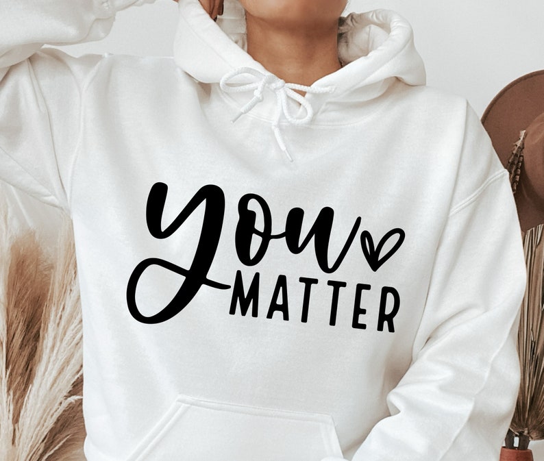 May include: White hoodie with black text that says "you matter" with a small heart symbol.