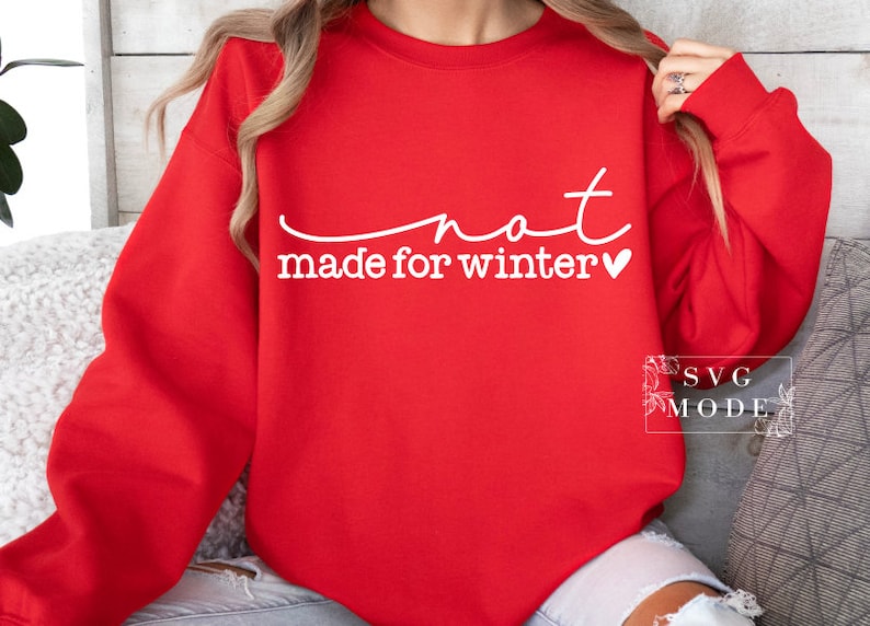 May include: Red sweatshirt with white text that reads "not made for winter" with a small heart symbol.