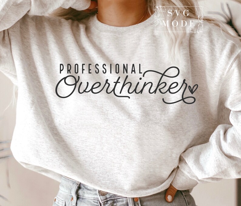 May include: A white sweatshirt with the text "Professional Overthinker" in black cursive lettering with a small heart symbol.