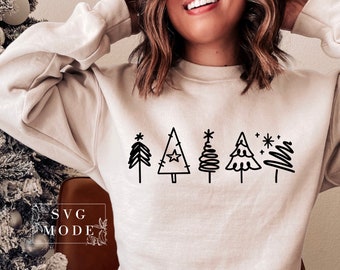 May include: A white sweatshirt with a black design of five stylized Christmas trees. The trees are arranged in a row and have different shapes and details. The design includes stars and snowflakes.