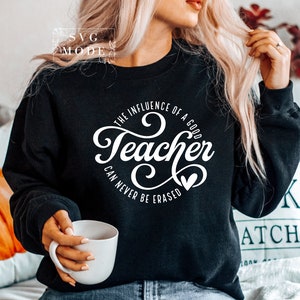 May include: Black sweatshirt with white text that reads "The influence of a good teacher can never be erased".