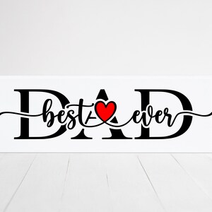 May include: Black and white sign with the word "DAD" in large letters. The letters "A" and "D" are connected by a red heart with the words "best ever" written in cursive between the letters.