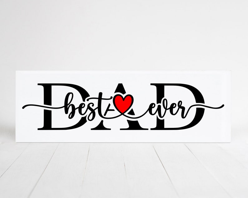 May include: Black and white sign with the word "DAD" in large letters. The letters "A" and "D" are connected by a red heart with the words "best ever" written in cursive between the letters.